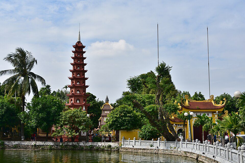 Tran Quoc Pagoda reflected in West Lake during sunset in Hanoi