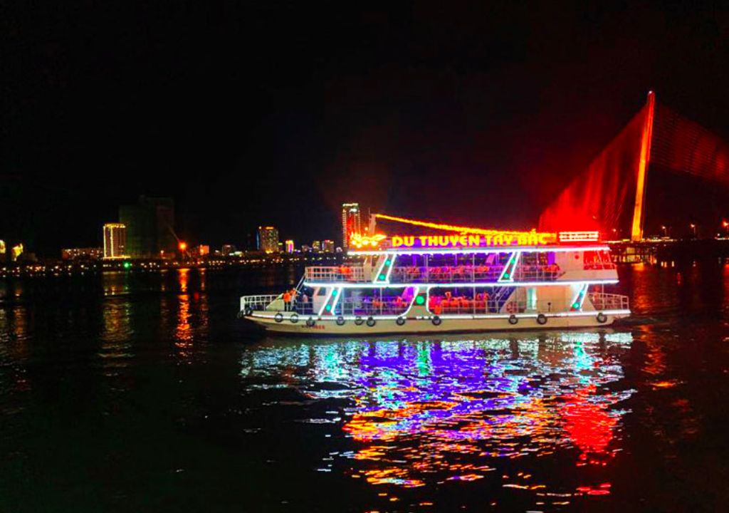 Night view from Han River cruise showing Danang's bridges lit up