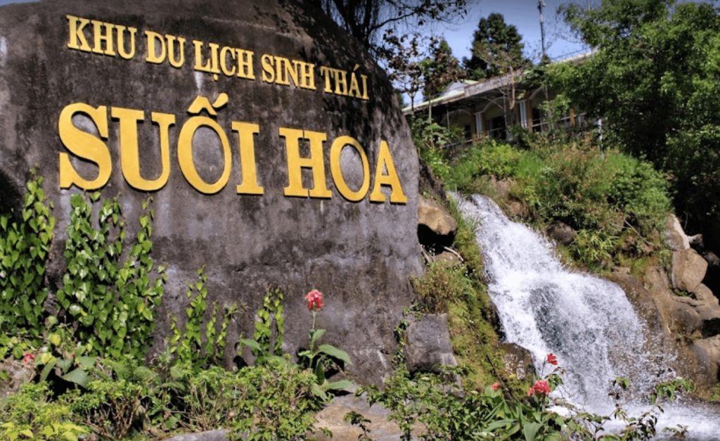 Visitors walking near a waterfall at Suoi Hoa Spring eco park in Da Nang, Vietnam