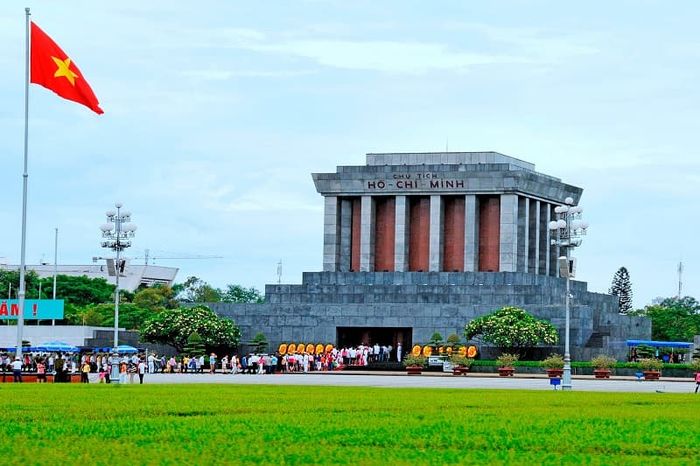 Front view of Ho Chi Minh Mausoleum in Hanoi with Vietnamese flags