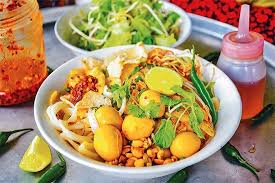 Mi Quang noodles with pork, shrimp, herbs, and rice crackers