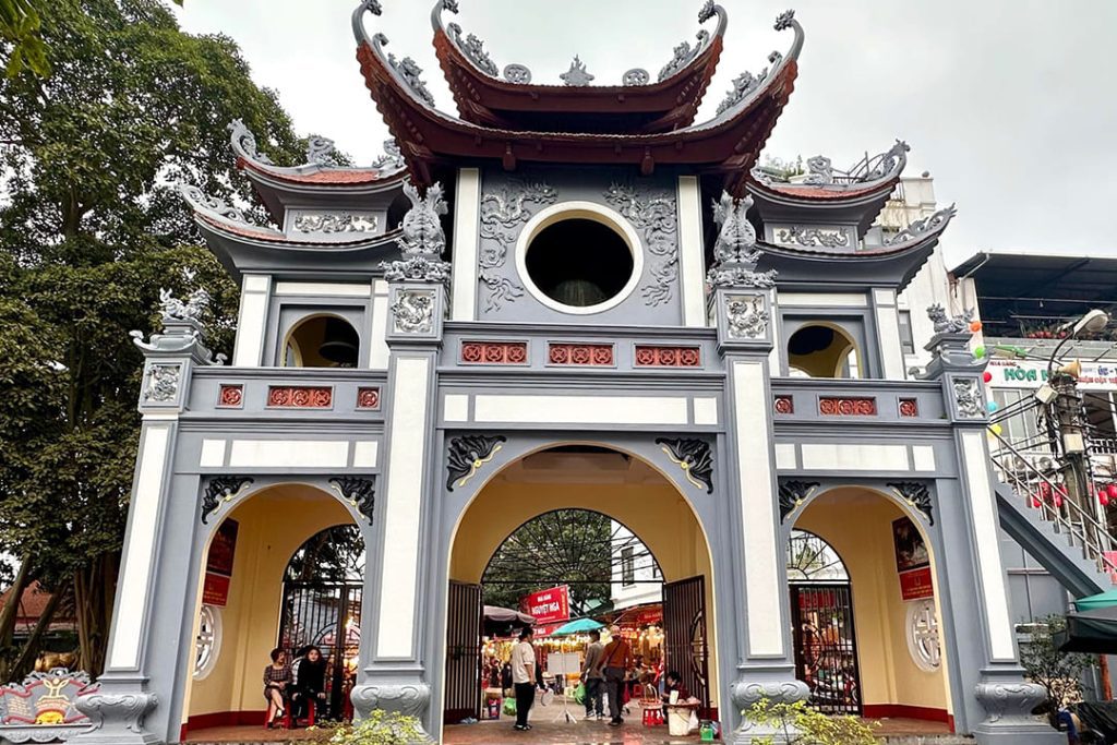 Visitors praying at Tay Ho Temple by the peaceful West Lake in Hanoi