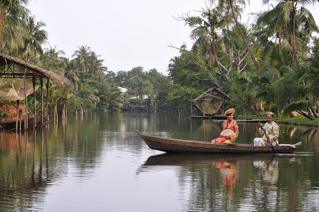 Binh Quoi tourist village with palm trees, river, and traditional thatched houses in Ho Chi Minh City
