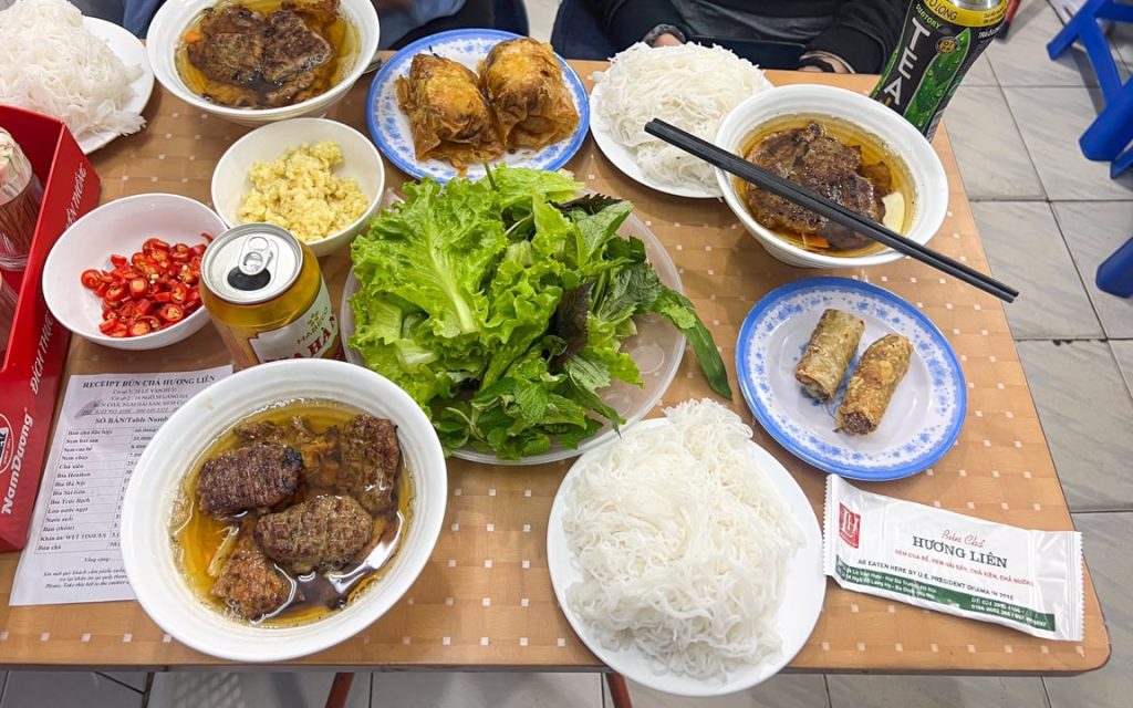 Grilled pork bun cha served with noodles, herbs, and dipping sauce in Hanoi, Vietnam