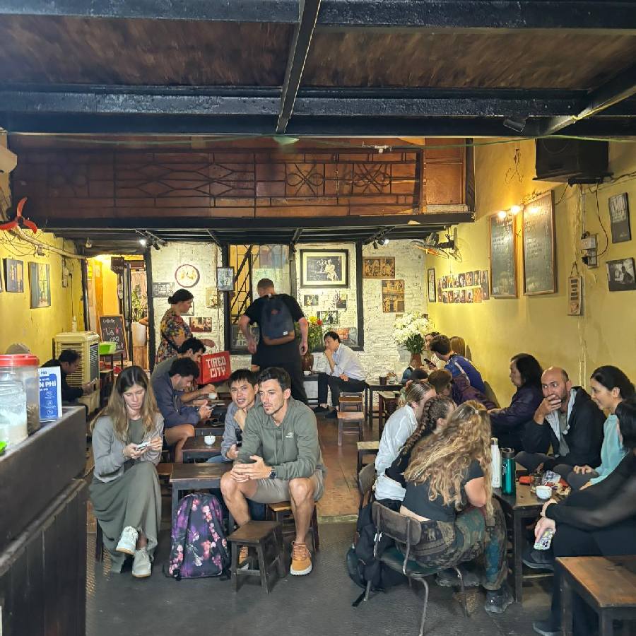 A cozy vintage café in Hanoi with retro furniture and soft yellow lighting