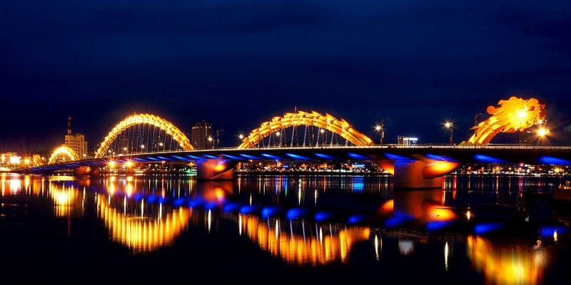 Golden Dragon Bridge breathing fire at night in Da Nang, Vietnam