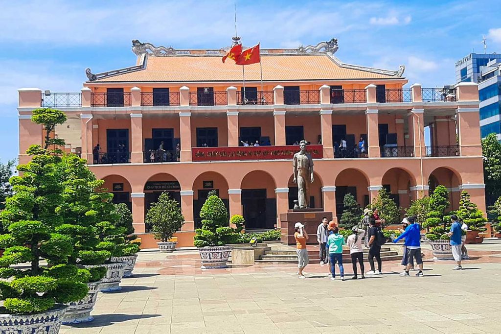 Front view of Ho Chi Minh Museum at Nha Rong Wharf with Vietnamese flag flying