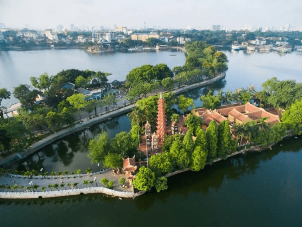 Couples walking along Thanh Nien Road at sunset with the lake on both sides