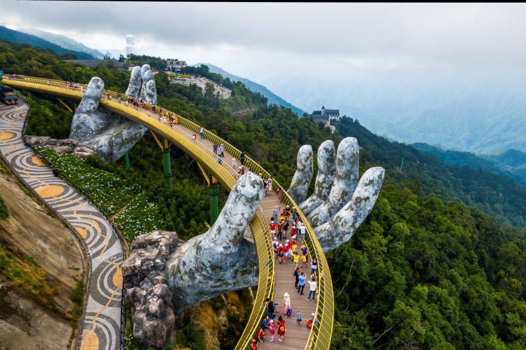 Golden Bridge at Ba Na Hills with misty mountains in the background