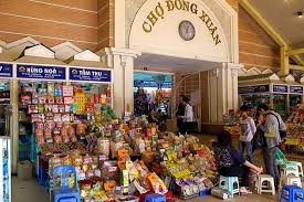 Busy entrance of Dong Xuan Market with locals and tourists shopping in Hanoi