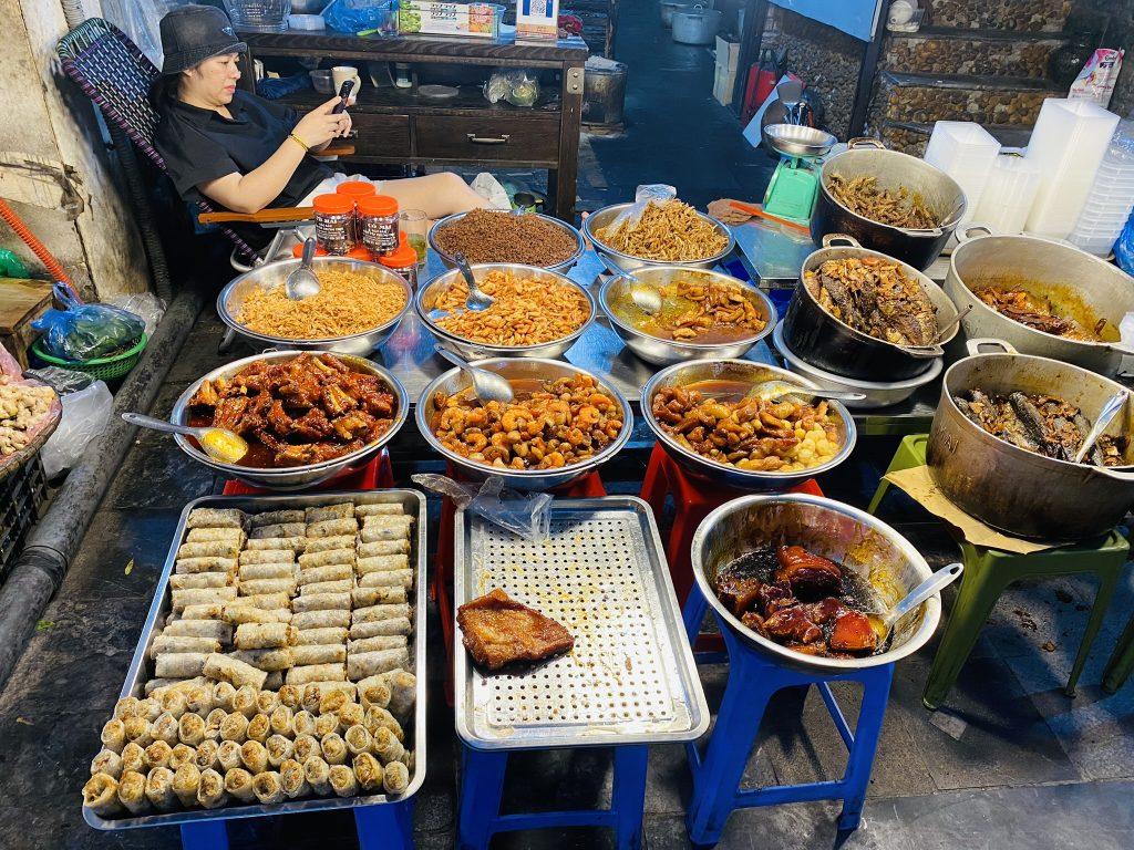 Street food vendor in Hanoi Old Quarter serving local snacks