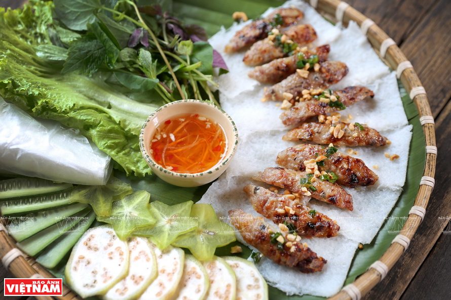 Various Vietnamese street snacks served on plastic trays including banh trang, grilled corn, and skewers