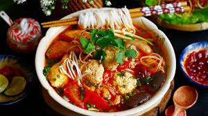 A steaming bowl of Hanoi crab noodle soup with tomatoes and tofu