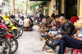 Young people drinking lemon tea near St. Joseph Cathedral in Hanoi