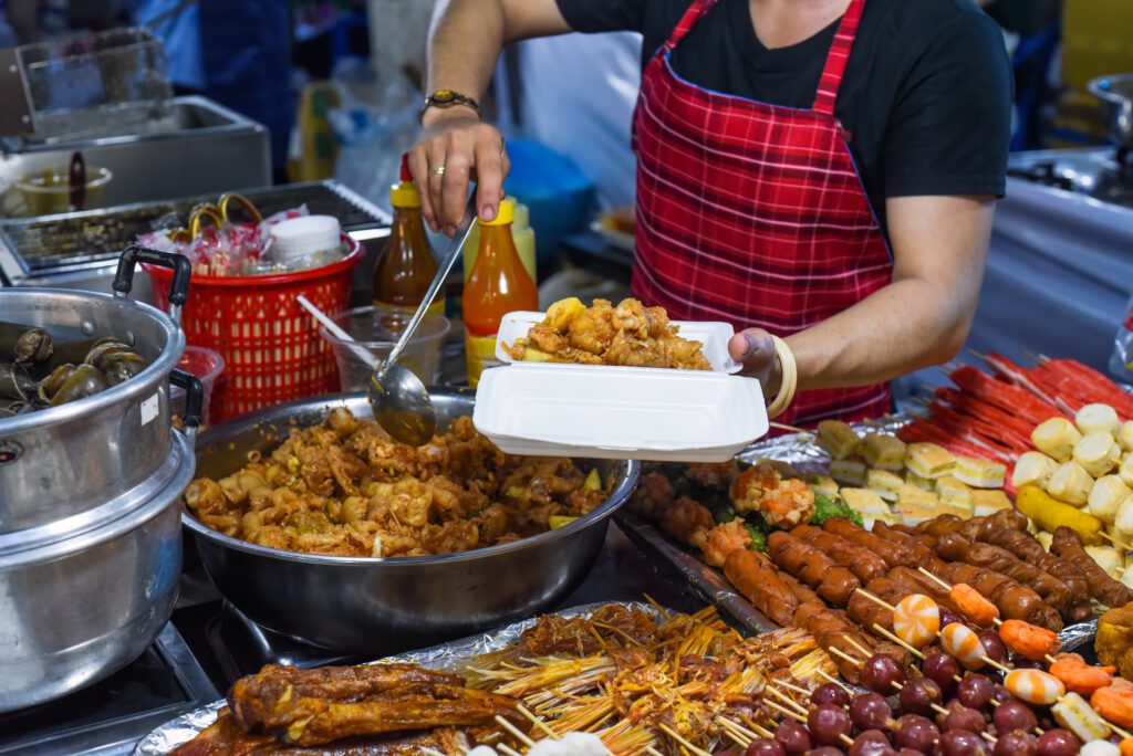 Street food vendor serving bánh mì in Saigon