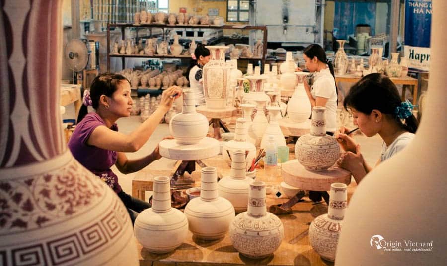 Traveler shaping clay during Bat Trang pottery-making tour in Hanoi