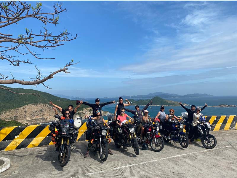 A group of friends riding motorbikes on a sunny day.